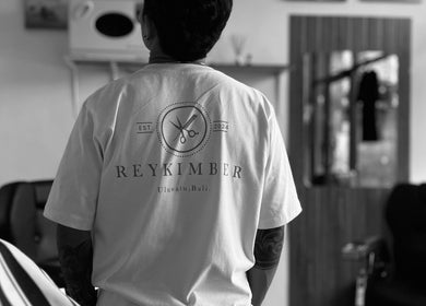 Back view of a person in Rey Kimber Barbershop uniform in Bali, Bali, ID.