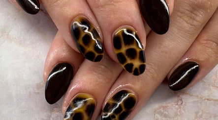 Stylish giraffe-pattern nail art at Belle Luxe Beauty in Crowthorne, England, GB. Perfect for bold fashion statements.