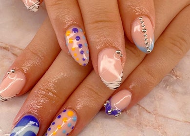Stylish nail art design at Belle Luxe Beauty, Crowthorne, England, GB featuring vibrant colors and patterns.