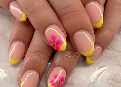 Vibrant yellow and pink floral nail art at Belle Luxe Beauty in Crowthorne, England, GB.