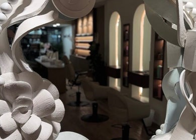 Stylish interior of Mahsa hair studio, Toronto, Ontario, CA with ornate mirror design.