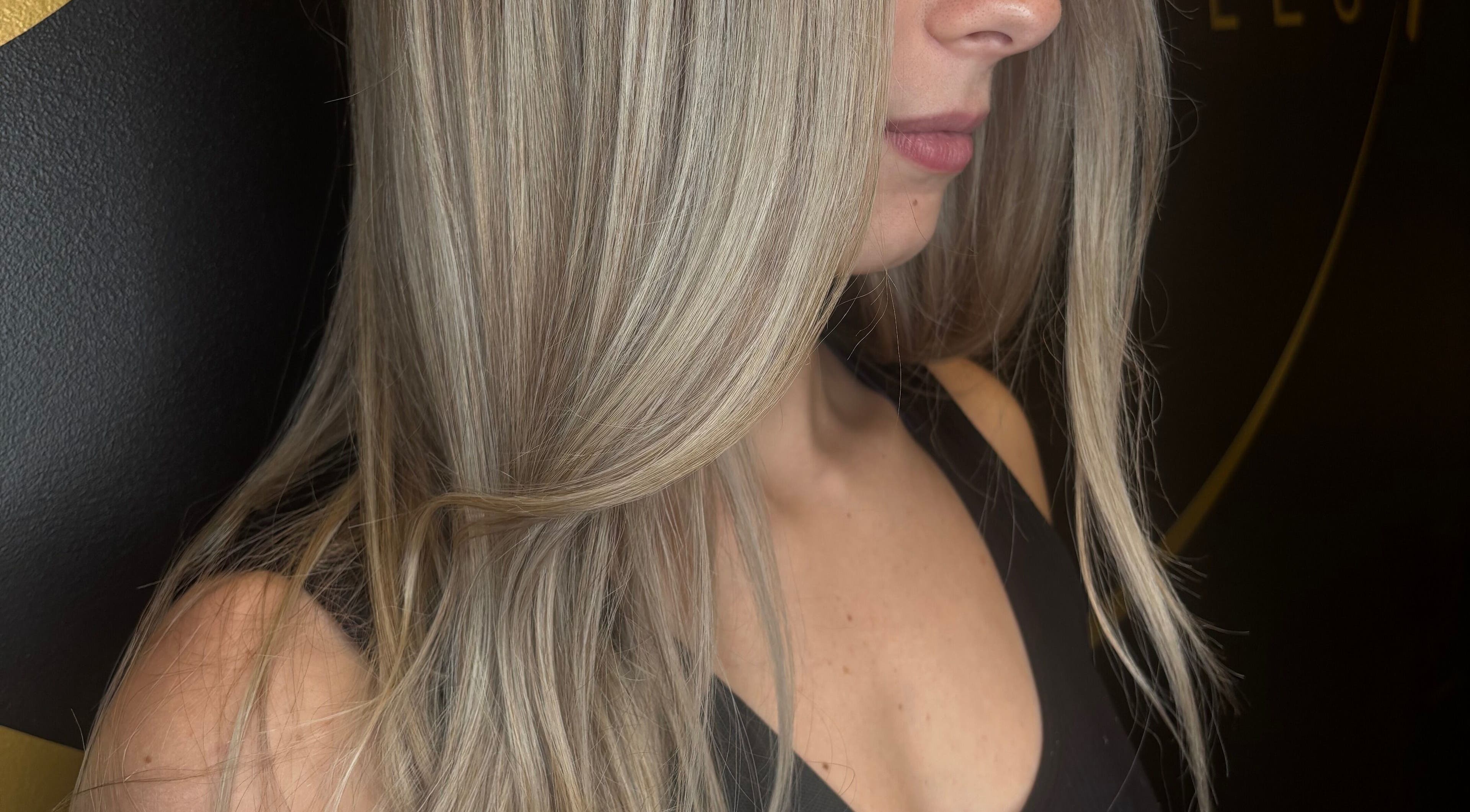 Close-up of woman with sleek blonde hair at Brianne Rae Styles, Smithtown, New York, US.