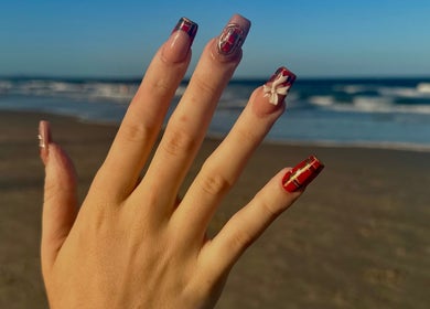 Elegant nail art at Buttercup Nails, North Lakes, Queensland, AU with an ocean backdrop.