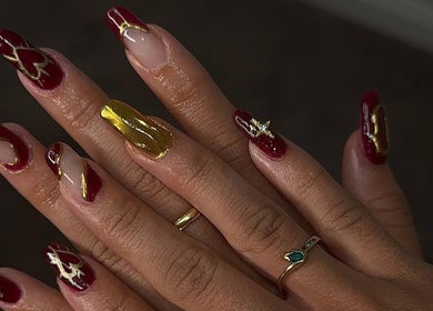 Elegant red and gold nail art design at Buttercup Nails, North Lakes, Queensland, AU.