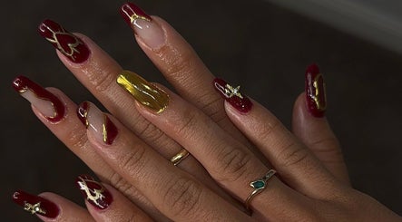 Elegant red and gold nail art design at Buttercup Nails, North Lakes, Queensland, AU.