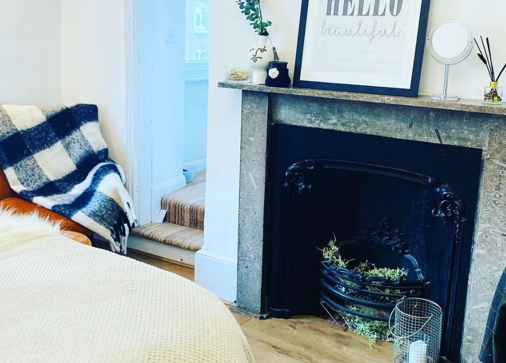 Comfortable seating by a fireplace at The Lavender Lounge, Carlton In Lindrick, England, GB.