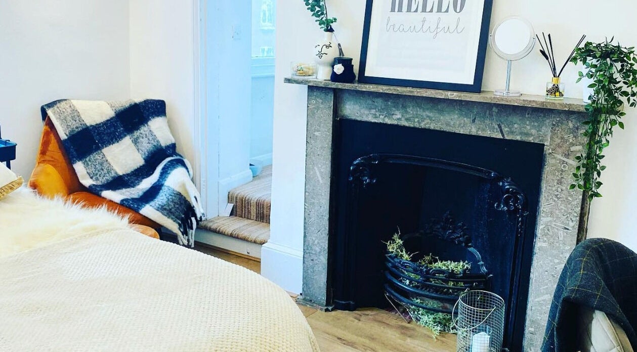 Comfortable seating by a fireplace at The Lavender Lounge, Carlton In Lindrick, England, GB.