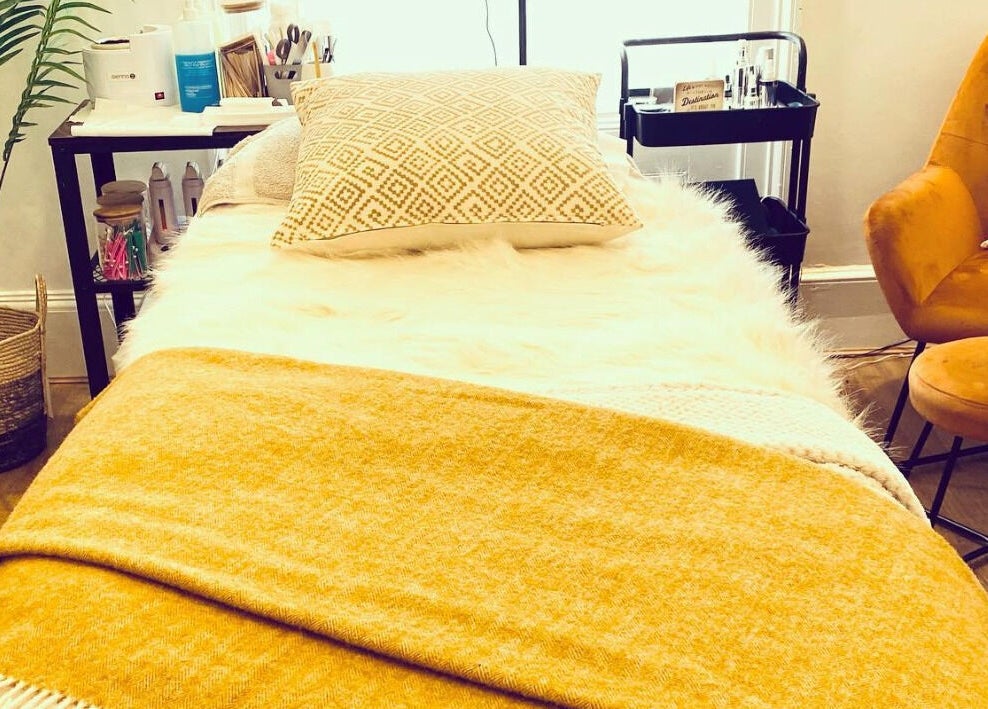 Relaxing treatment room at The Lavender Lounge, Carlton In Lindrick, England, GB with soft yellow decor.