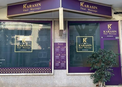 Front view of Kalasin Thai Massage Algés in Algés, Lisboa, PT with purple signage and plants.