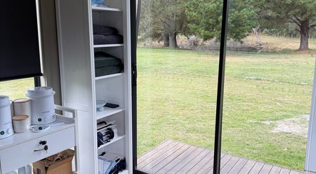 Bright spa interior at Always Natural Beauty in Longford, Victoria, AU, overlooking a tranquil green landscape.