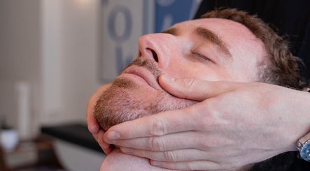 Gentle face massage at Pow Slap Barbers, Knutsford, England, GB, offering a relaxing shaving experience.