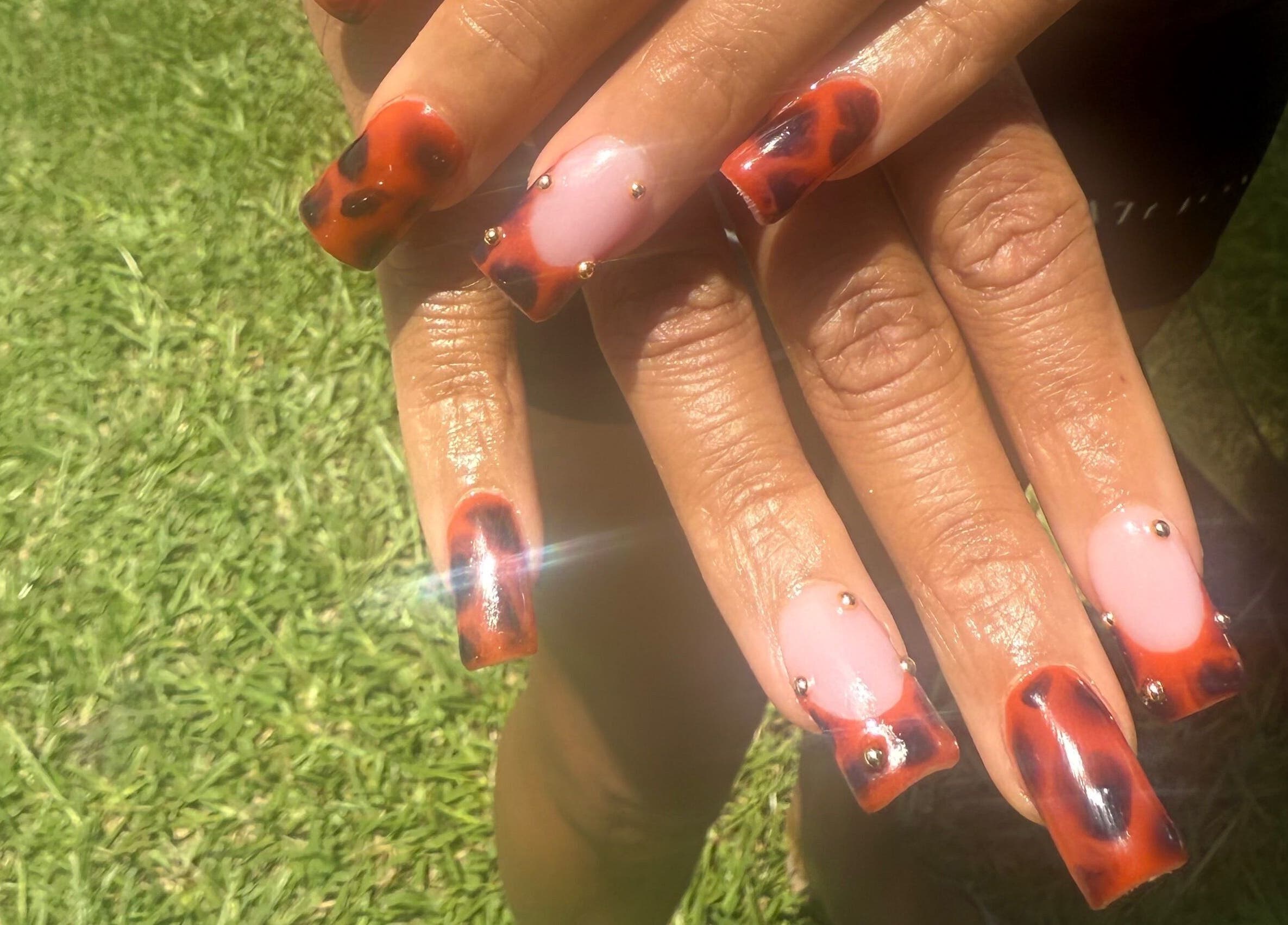 Tortoise shell nail art with gold accents at Hart of Nails, Fayetteville, North Carolina, US.