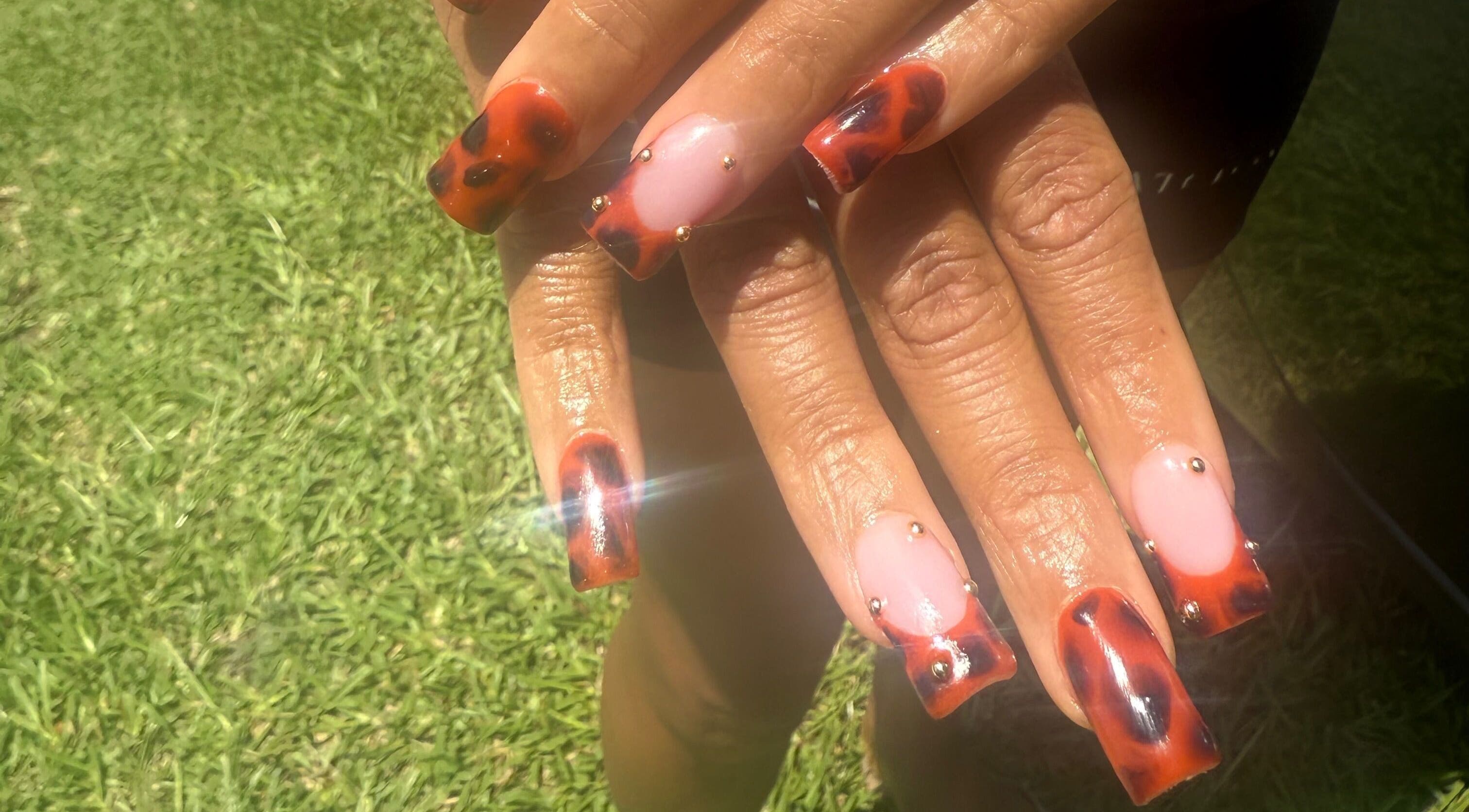Tortoise shell nail art with gold accents at Hart of Nails, Fayetteville, North Carolina, US.