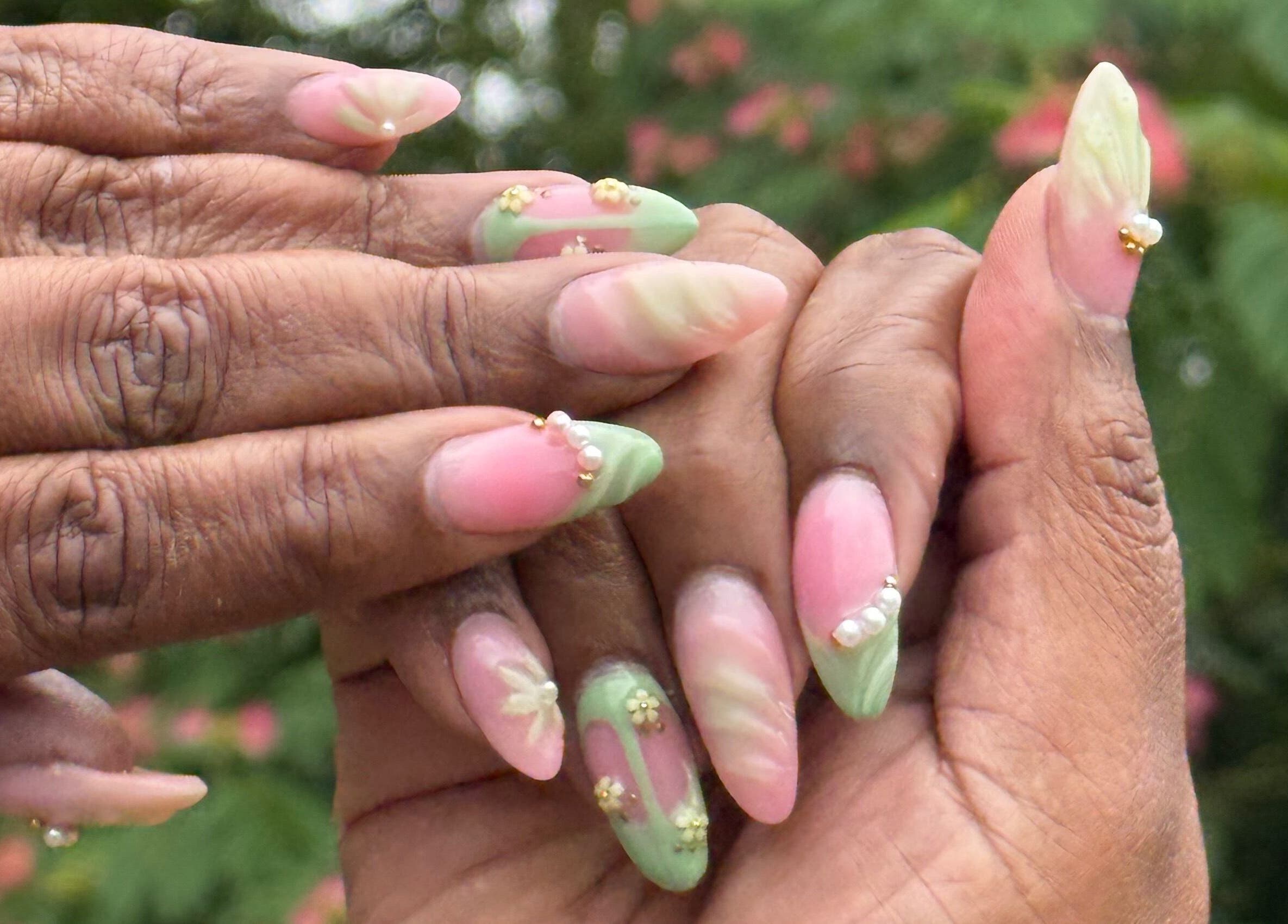 Detailed nail art featuring pastel pink and green at Hart of Nails, Fayetteville, North Carolina, US.