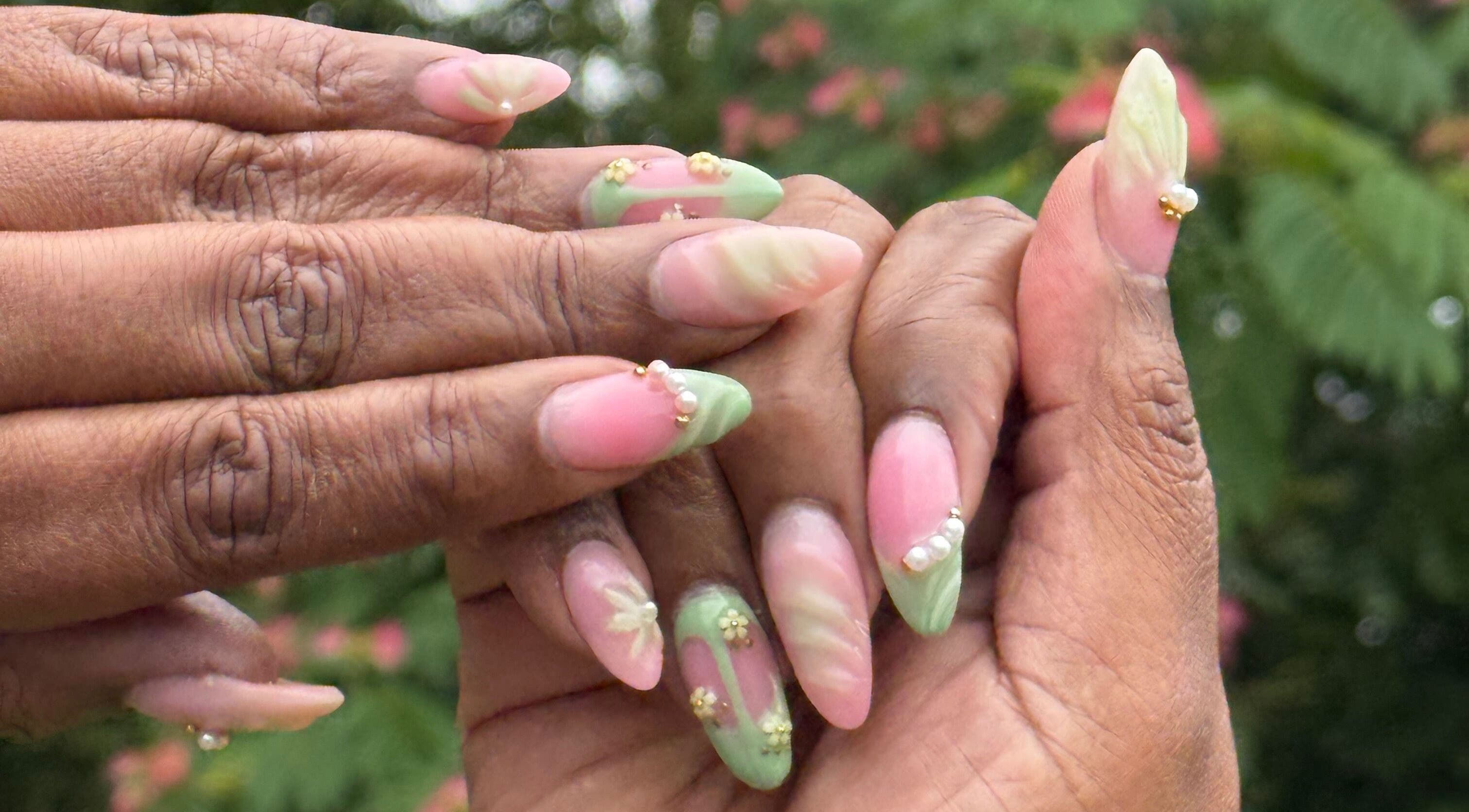 Detailed nail art featuring pastel pink and green at Hart of Nails, Fayetteville, North Carolina, US.
