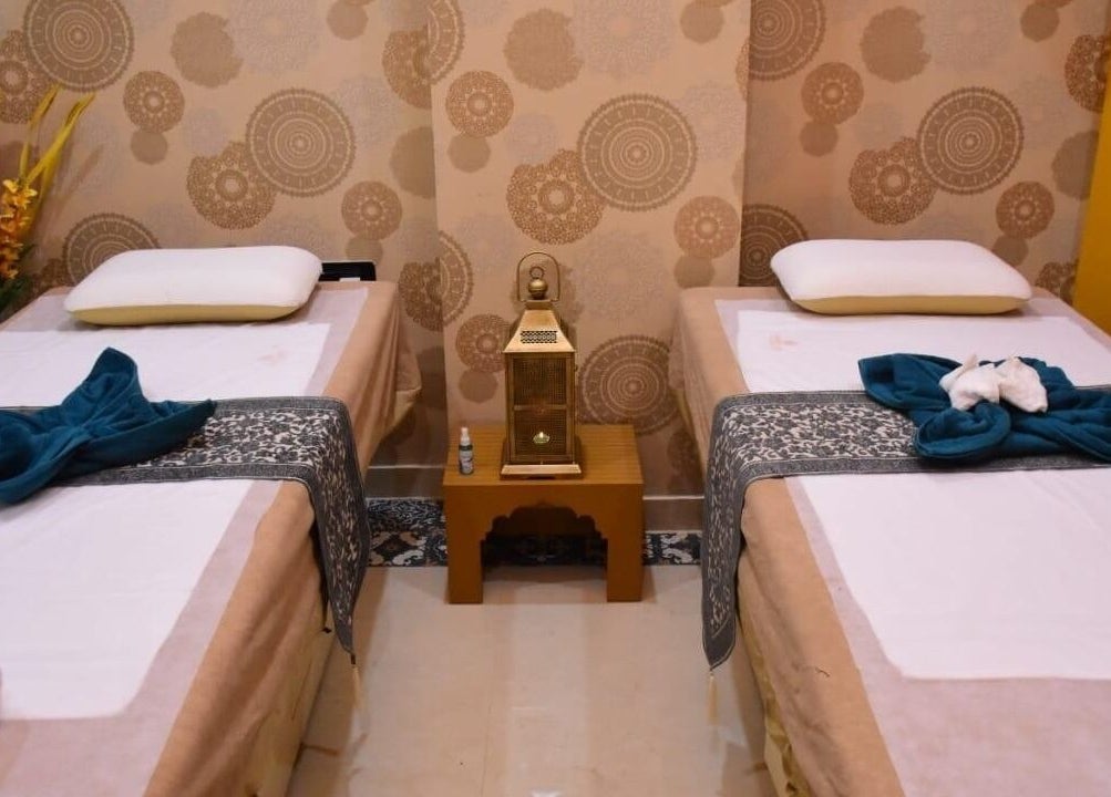 Elegant dual massage beds at Moroccan Spa, Lucknow, Uttar Pradesh, IN, featuring calming decor and floral accents.