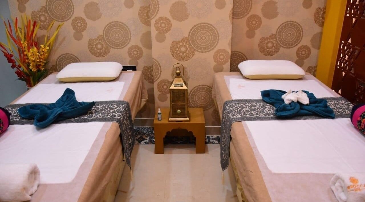Elegant dual massage beds at Moroccan Spa, Lucknow, Uttar Pradesh, IN, featuring calming decor and floral accents.