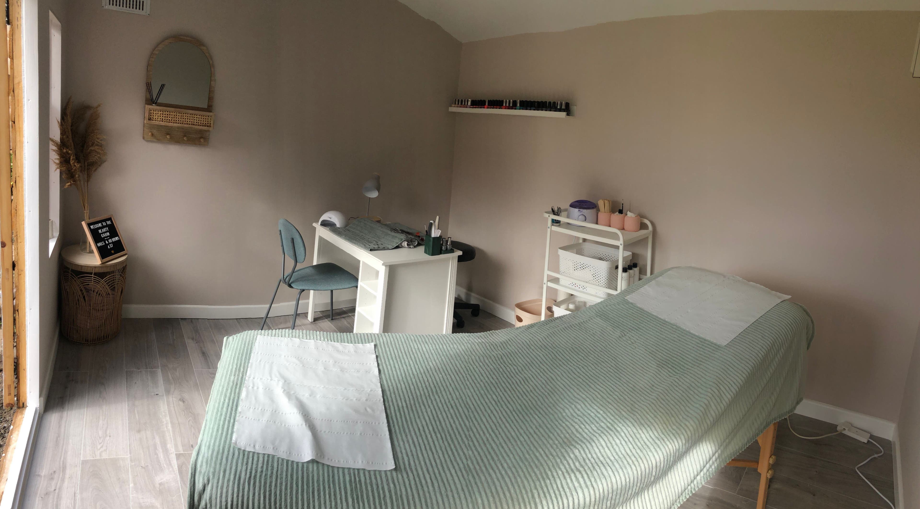 Serene treatment room at Clare Ervine Beauty, Dundonald, Northern Ireland, GB, featuring a massage bed and desk.