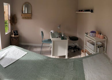 Calm treatment room at Clare Ervine Beauty, Dundonald, Northern Ireland, GB, showcasing a serene setup with green accents.