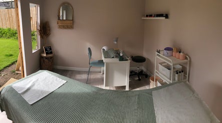 Calm treatment room at Clare Ervine Beauty, Dundonald, Northern Ireland, GB, showcasing a serene setup with green accents.