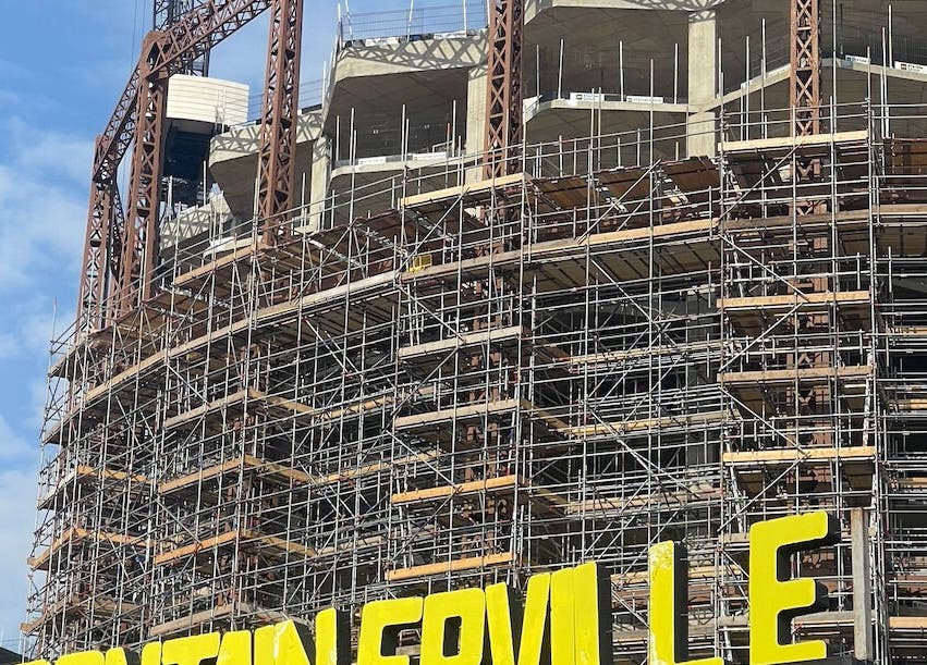 Construction site near The Hackney Osteopath in London, England, GB, framed by scaffolding.