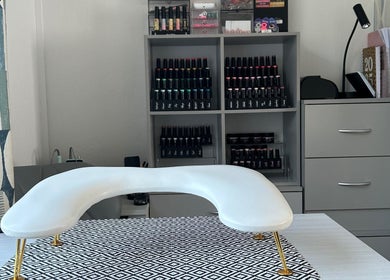 Nail care station at NailsByAmyMaree in Penzance, England, GB, featuring organized polish display.