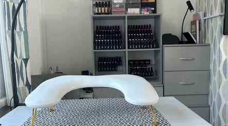 Nail care station at NailsByAmyMaree in Penzance, England, GB, featuring organized polish display.