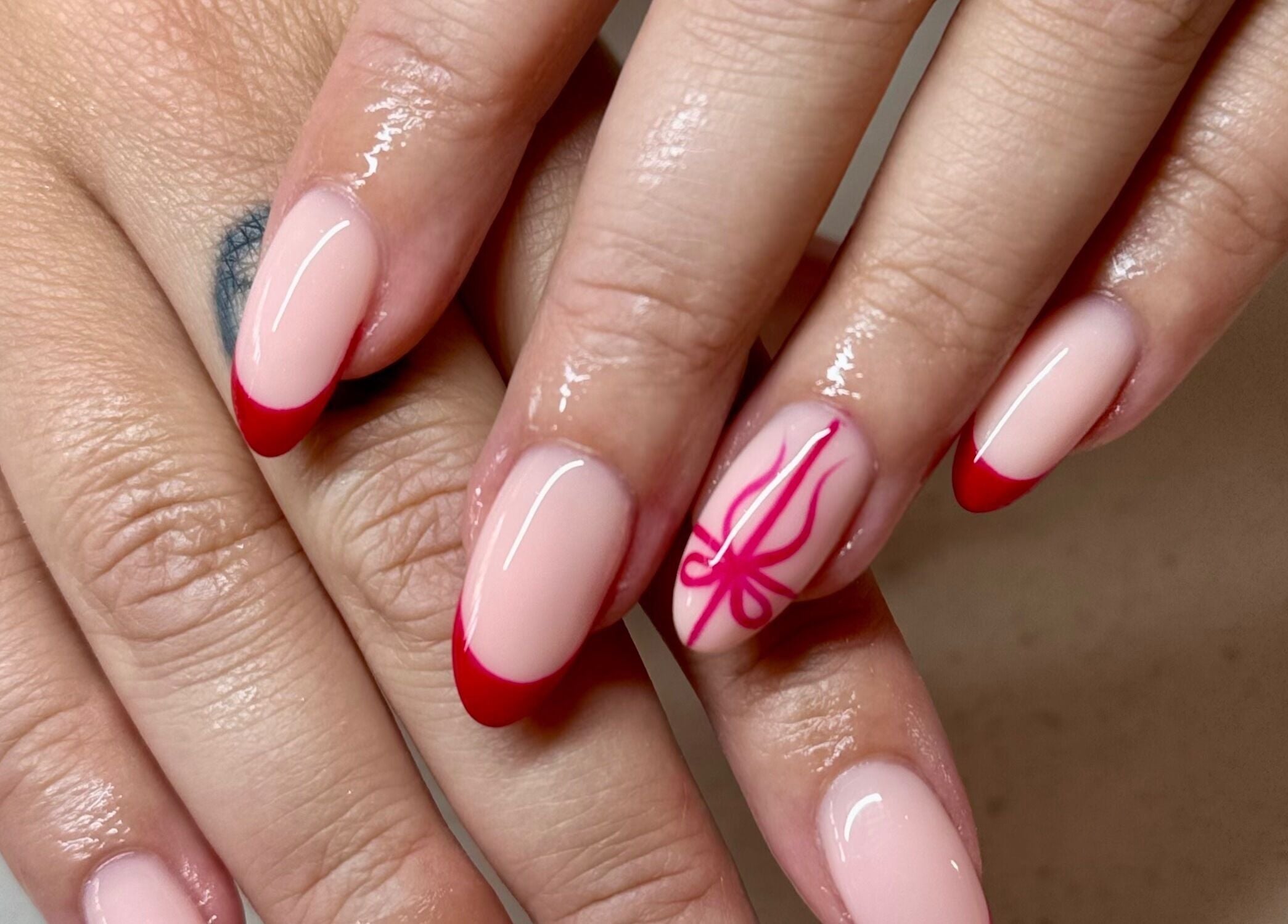 Stylish red-tipped nails with artistic design at Glam Nail Studio, Melbourne, Victoria, AU.