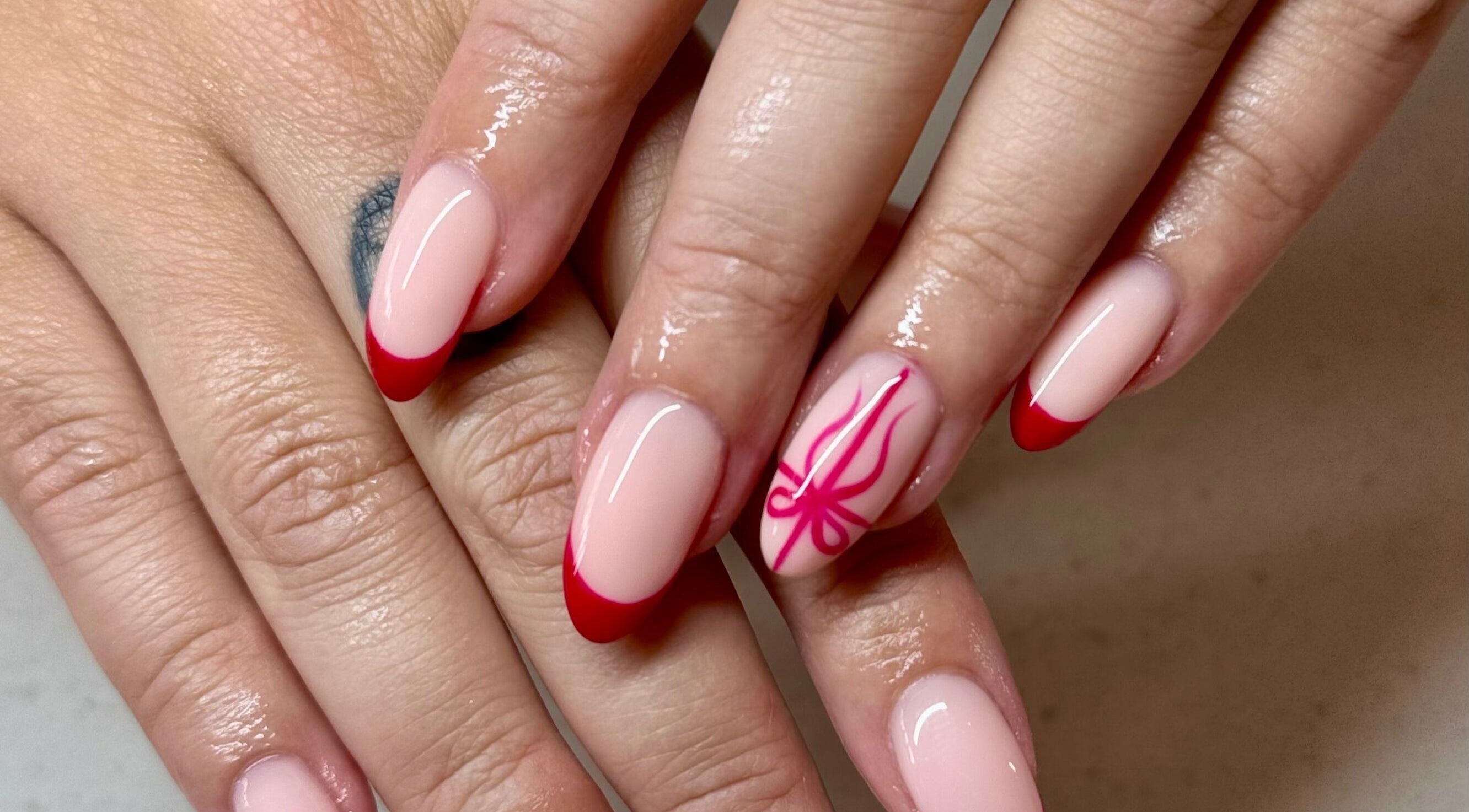 Stylish red-tipped nails with artistic design at Glam Nail Studio, Melbourne, Victoria, AU.