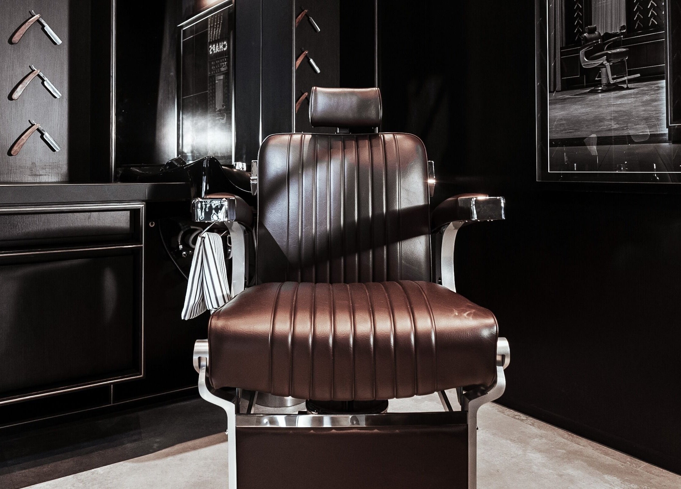 Luxurious barber chair at Chaps & Co - Vida Creek Beach, Dubai, Dubai, AE. Sleek and stylish grooming space.