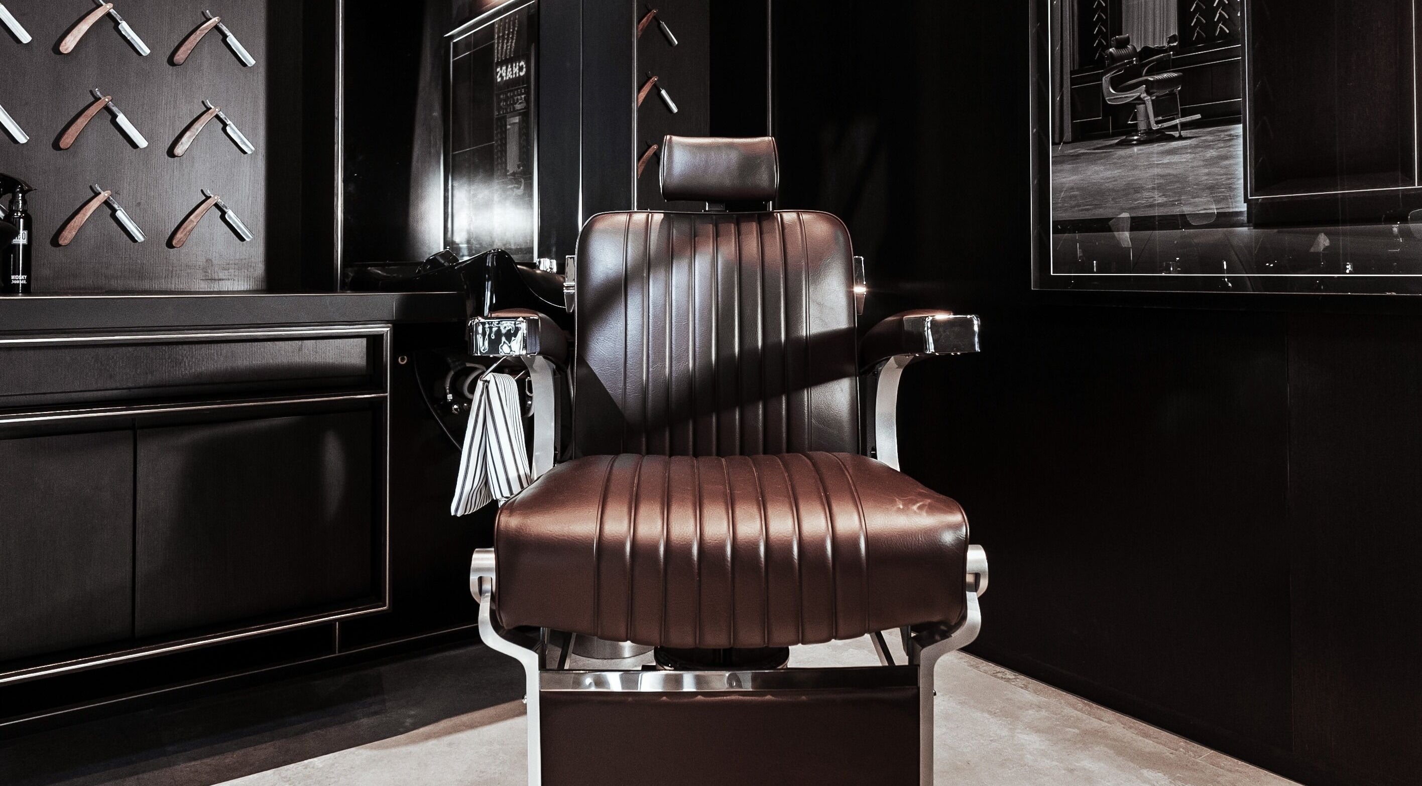 Luxurious barber chair at Chaps & Co - Vida Creek Beach, Dubai, Dubai, AE. Sleek and stylish grooming space.