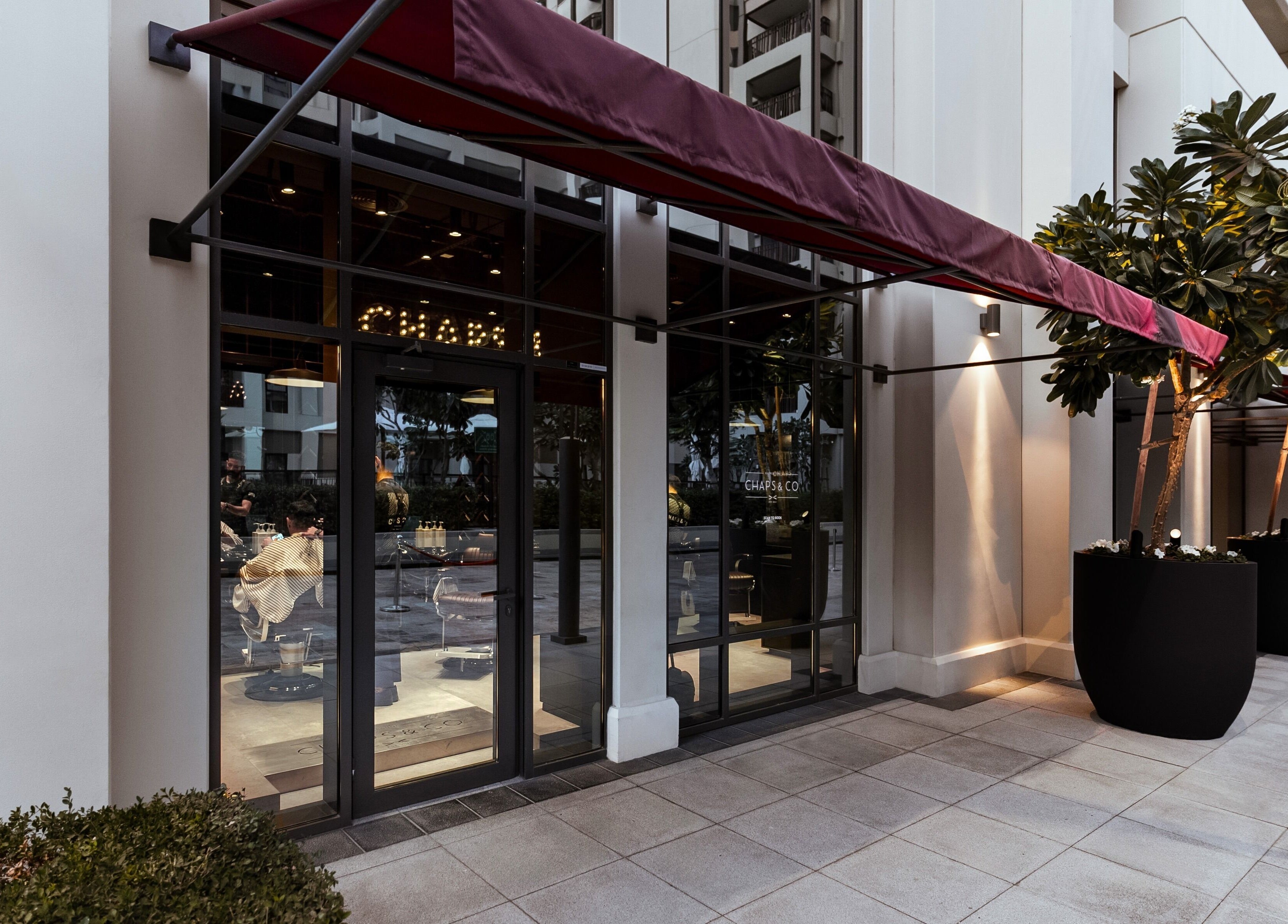 Entrance of Chaps & Co - Vida Creek Beach with a red awning in Dubai, Dubai, AE.