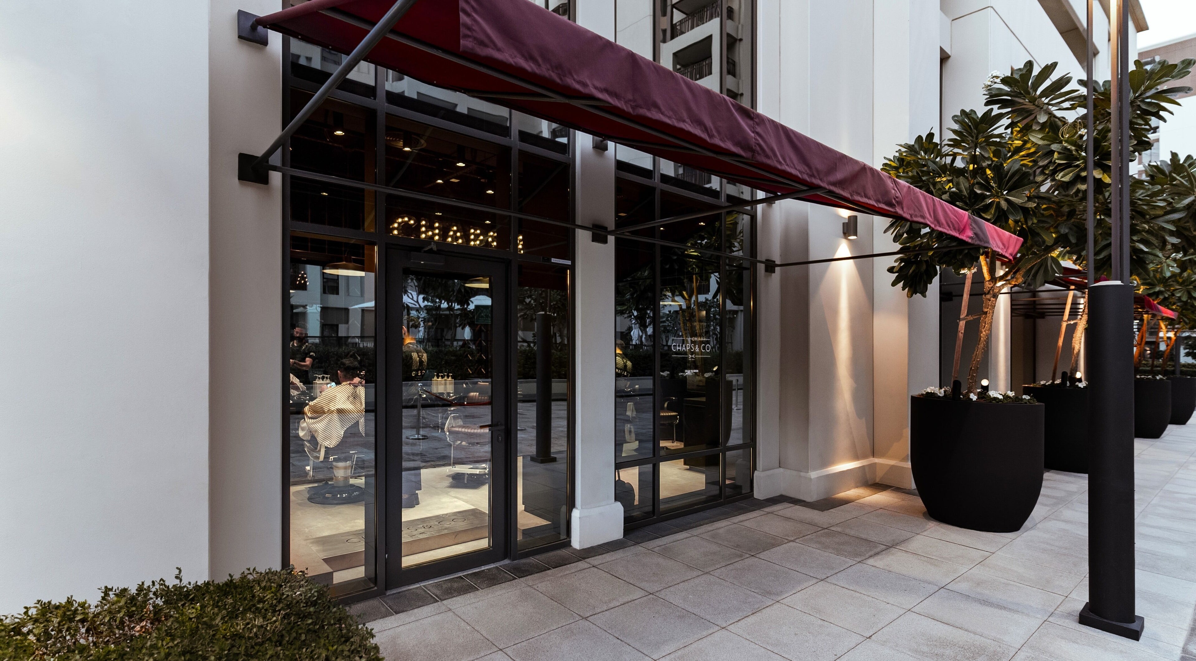 Entrance of Chaps & Co - Vida Creek Beach with a red awning in Dubai, Dubai, AE.