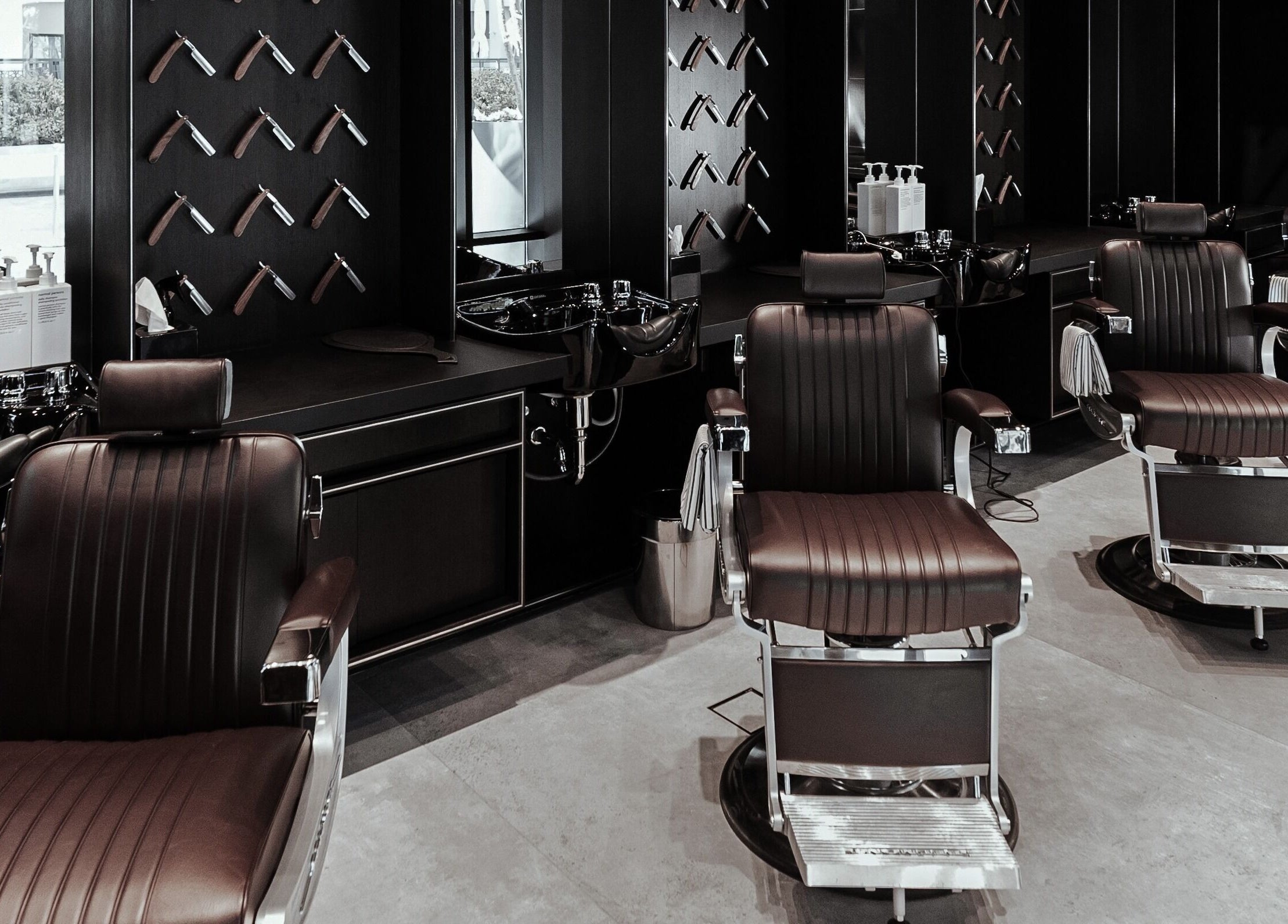 Modern barber chairs at Chaps & Co - Vida Creek Beach in Dubai, Dubai, AE, offering premium grooming services.