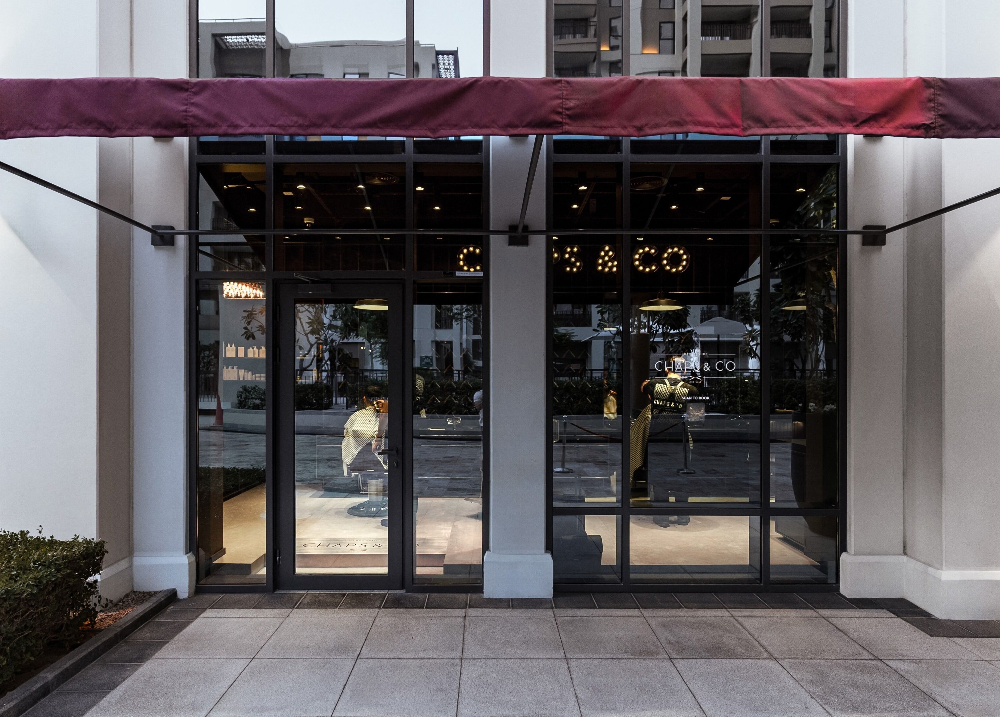 Chaps & Co - Vida Creek Beach entrance in Dubai, Dubai, AE with modern glass doors and elegant awning.