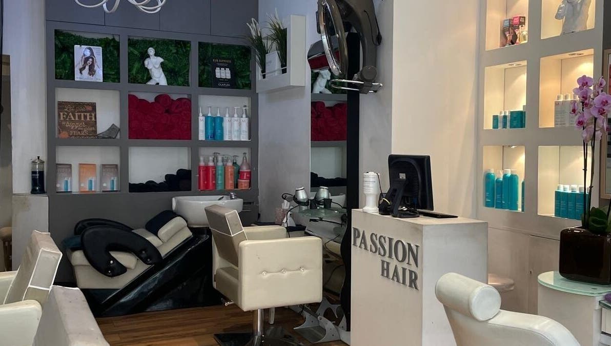 Interior view of Passion Hair salon in London, England, showcasing elegant seating and modern decor.