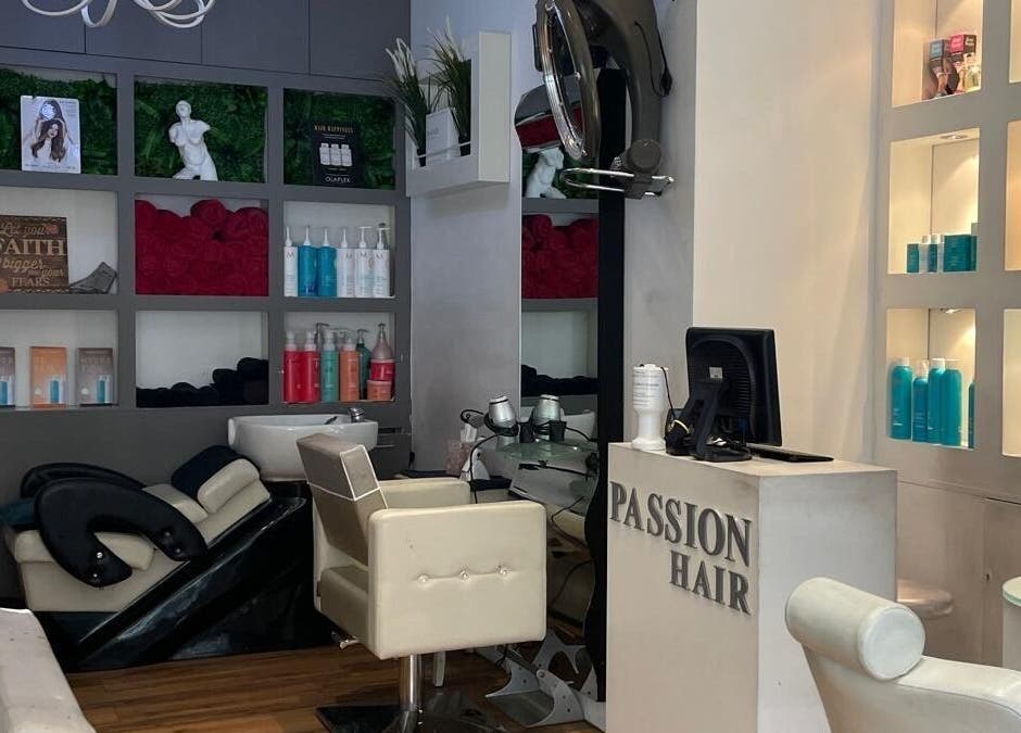 Interior view of Passion Hair salon in London, England, showcasing elegant seating and modern decor.