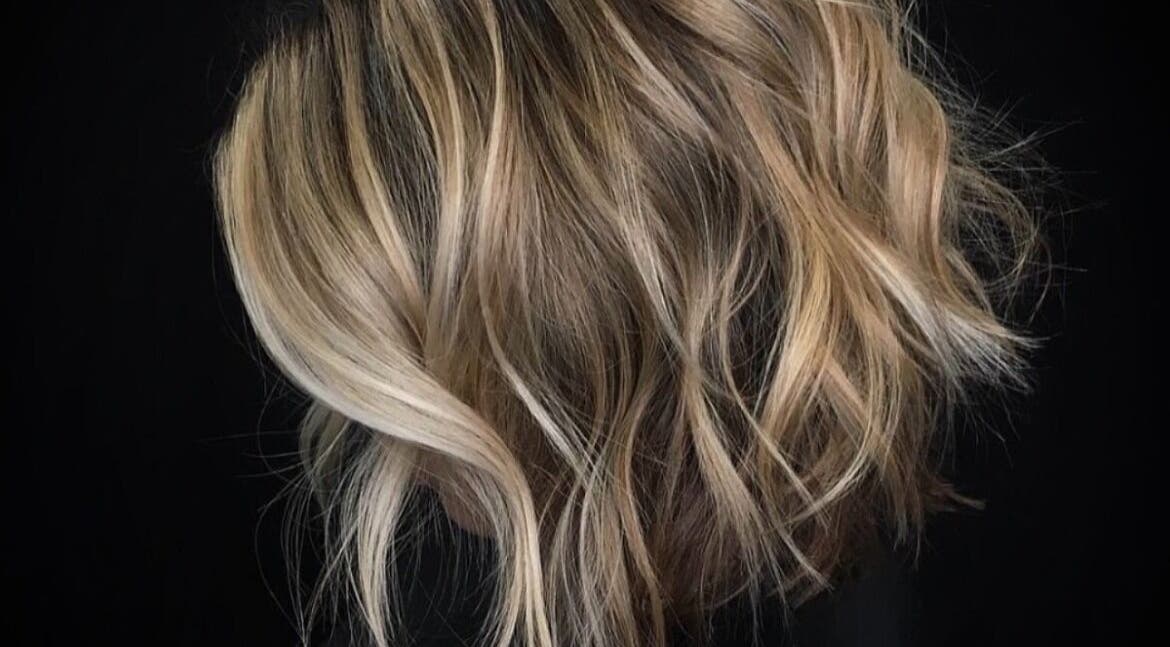 Blonde wavy hair styled at Passion Hair, London, England, GB, showcasing chic elegance and modern style.