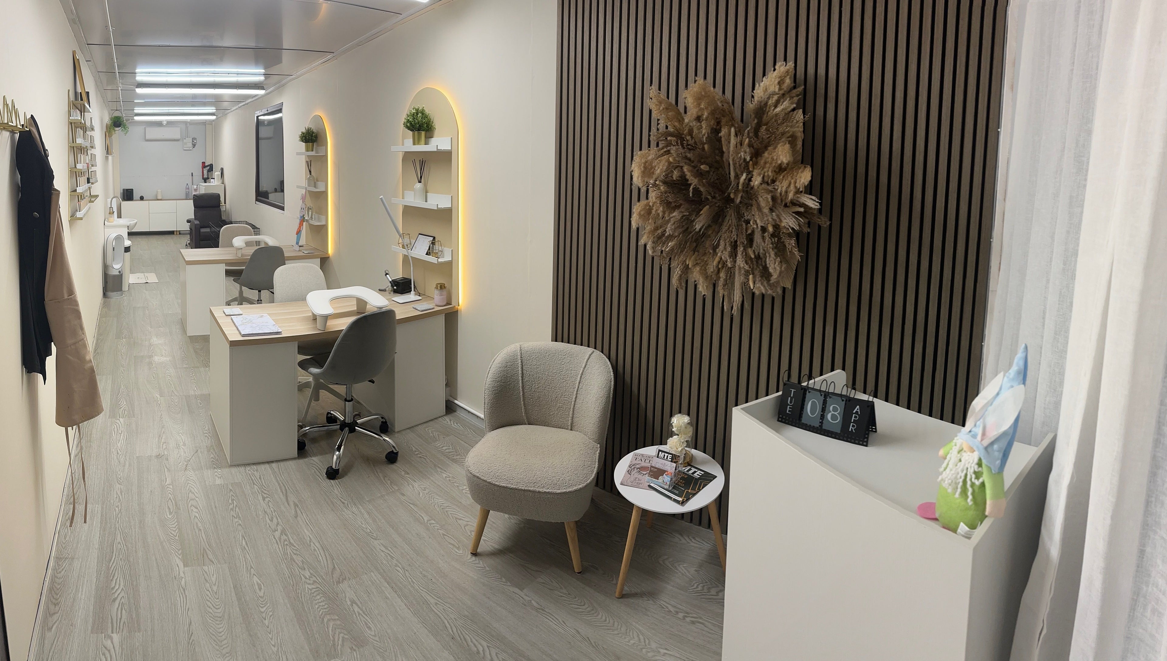 Chic interior of Luxe Enhancements in Rochester, England, GB with stylish workstations and plush seating.