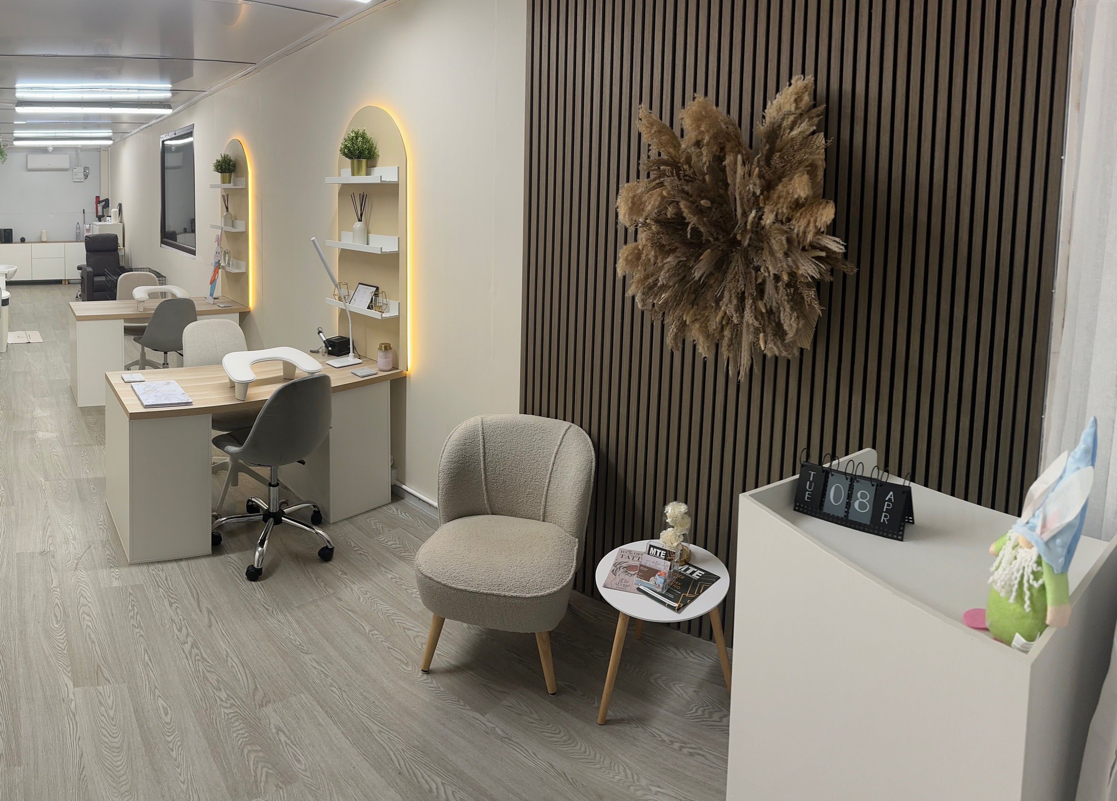 Chic interior of Luxe Enhancements in Rochester, England, GB with stylish workstations and plush seating.