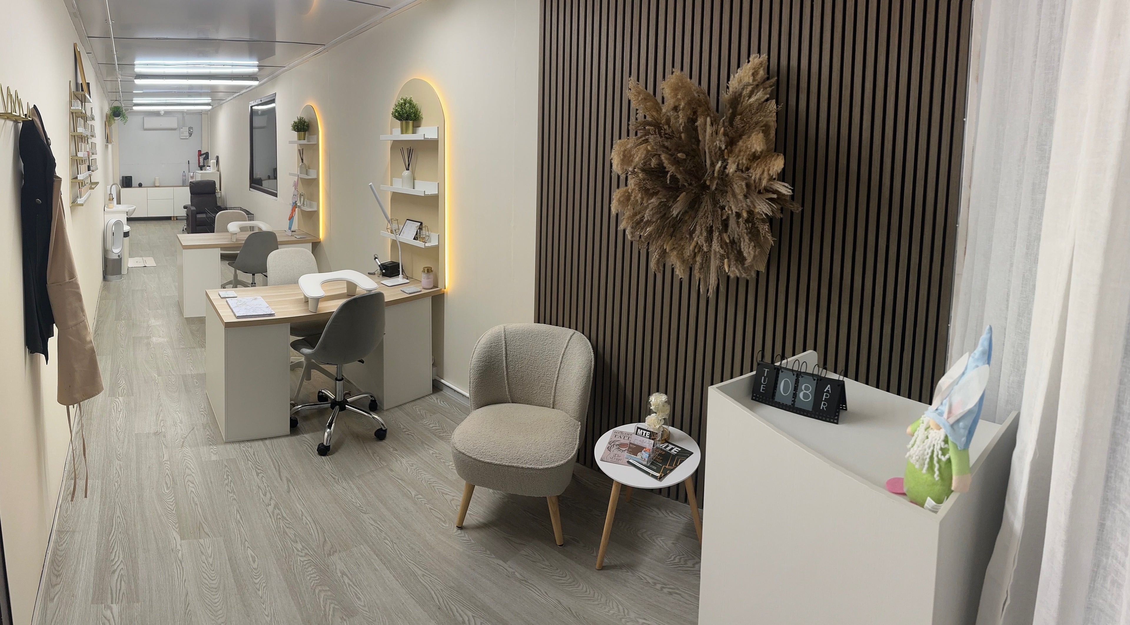 Chic interior of Luxe Enhancements in Rochester, England, GB with stylish workstations and plush seating.
