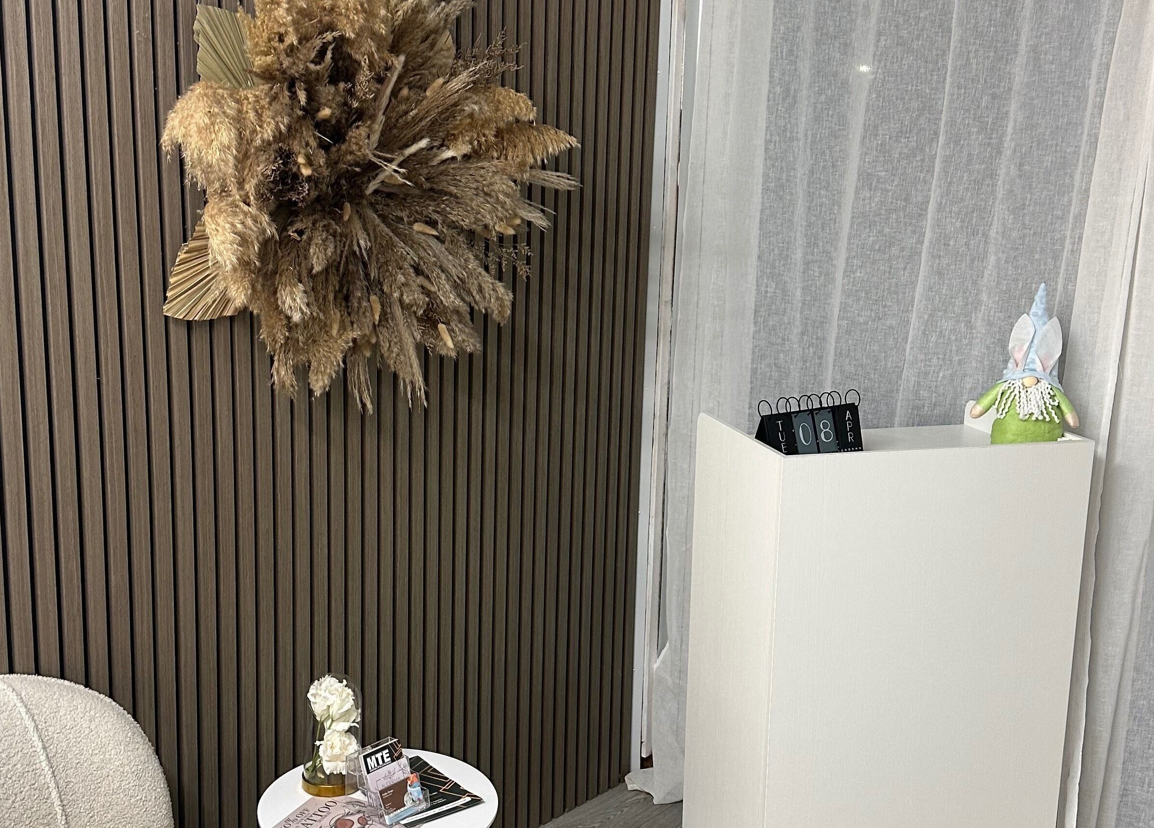 Chic decor at Luxe Enhancements, Rochester, England, GB with dried floral display and cozy seating.