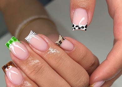 Stylish mani with artistic tips at Glitz&GlamNailBar, Winsford, England, GB in vibrant animal prints.