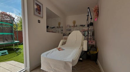 A cozy treatment room at Aglow by VL, Essington, England. Features a comfortable chair facing a garden.