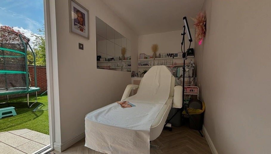 Relaxing treatment room at Aglow by VL, Essington, England, GB. A comfortable chair amidst tranquil decor.