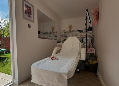 Relaxing treatment room at Aglow by VL, Essington, England, GB. A comfortable chair amidst tranquil decor.