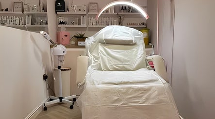 Modern treatment room at Aglow by VL, Essington, England, GB, featuring a luxurious spa bed and ambient lighting.