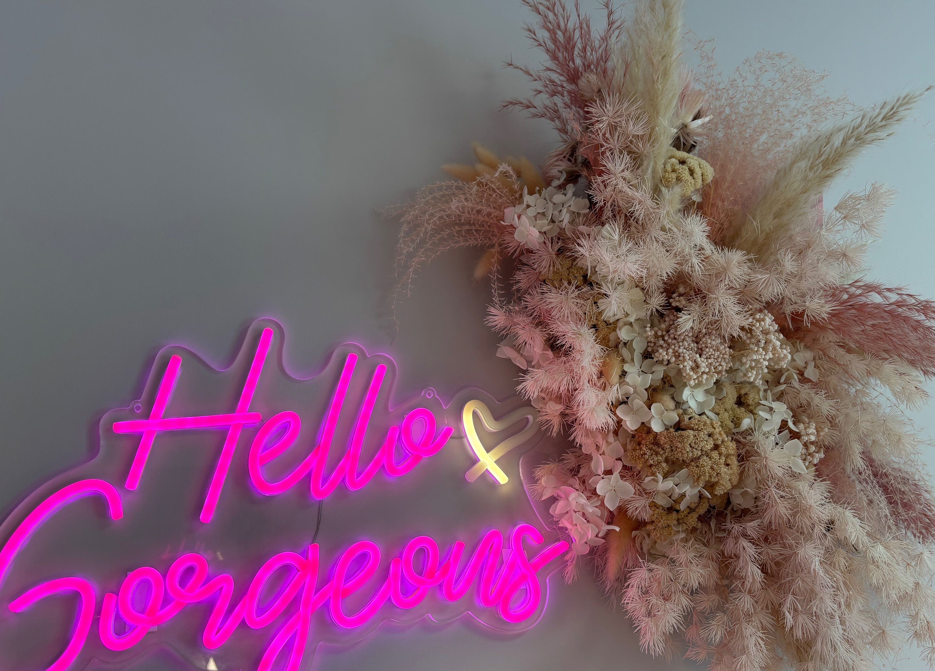 Neon sign 'Hello Gorgeous' with floral decor at Aglow by VL, Essington, England, GB.