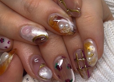 Elegant artistic nail design at Pressed Beans, Montréal, Québec, CA, featuring unique patterns and embellishments.