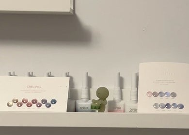 Shelves at Pressed Beans, Montréal, Québec, CA displaying beauty products and color charts.